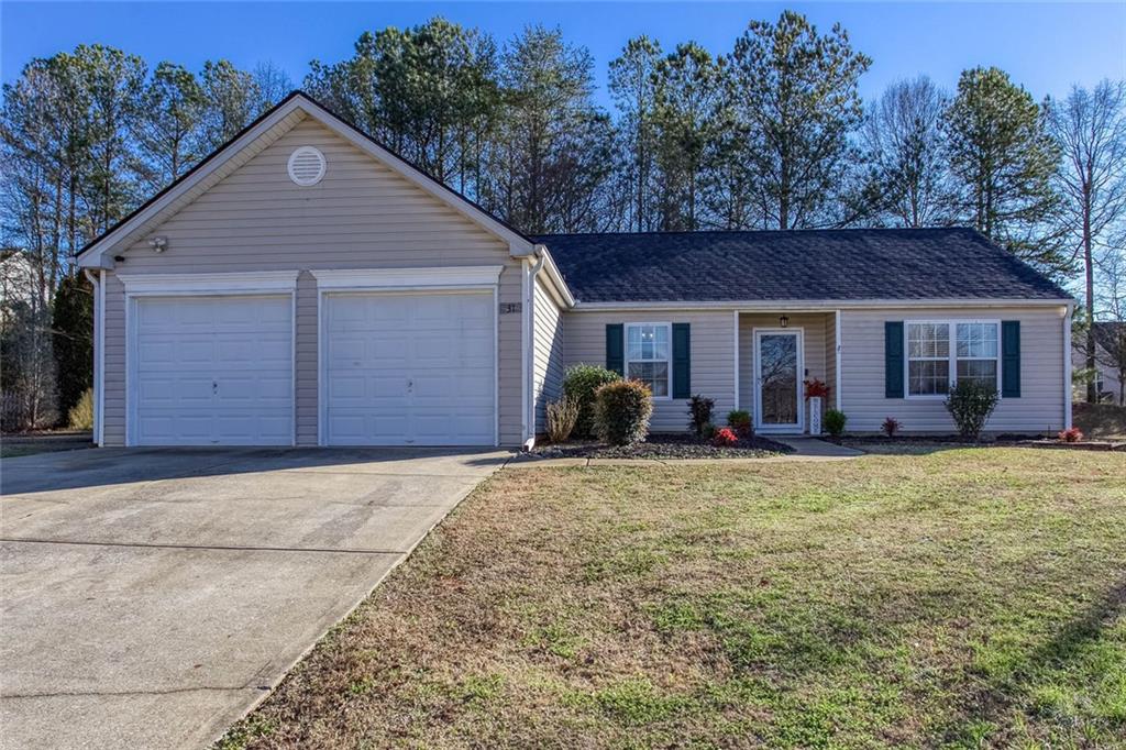 31 Abbey Lane Cartersville, GA 30120 - Photo 3 of 34 a front view of a house with a garden and porch