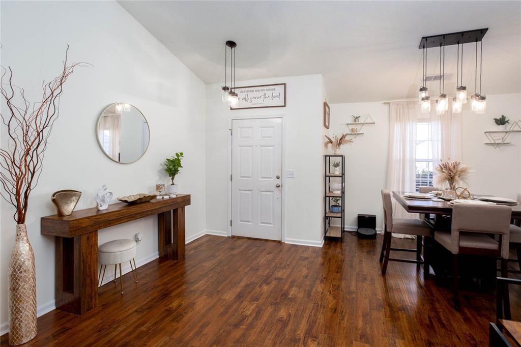 31 Abbey Lane Cartersville, GA 30120 - Photo 5 of 34 a living room with table chairs and a wooden floor