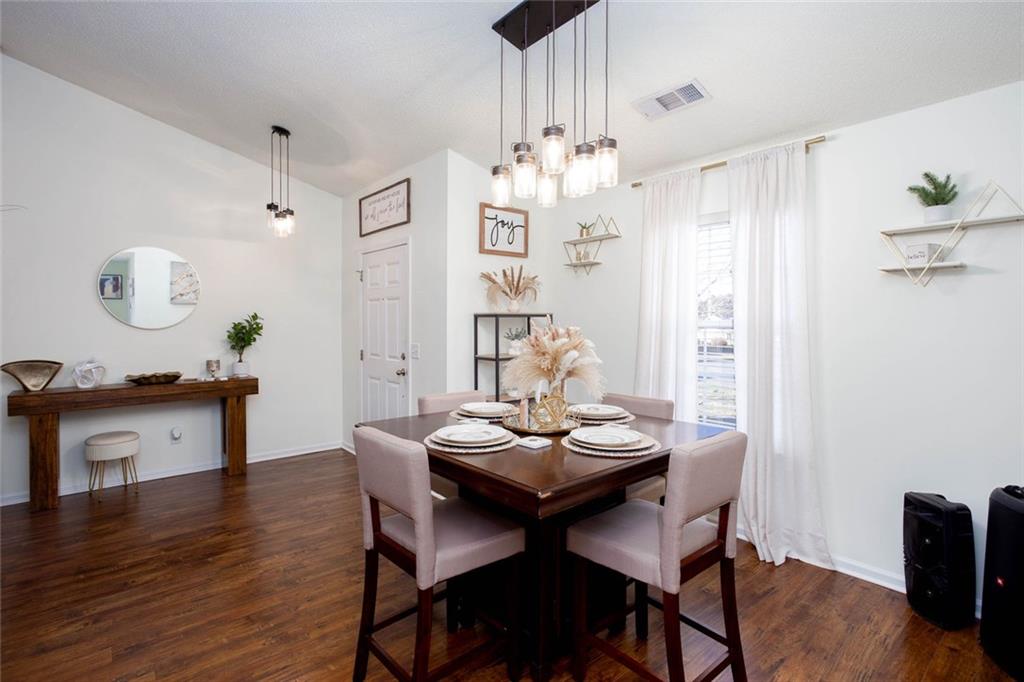 31 Abbey Lane Cartersville, GA 30120 - Photo 6 of 34 a view of a dining room with furniture a chandelier and wooden floor
