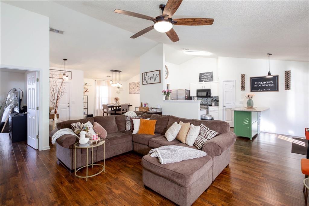 31 Abbey Lane Cartersville, GA 30120 - Photo 9 of 34 a living room with furniture kitchen view and a chandelier
