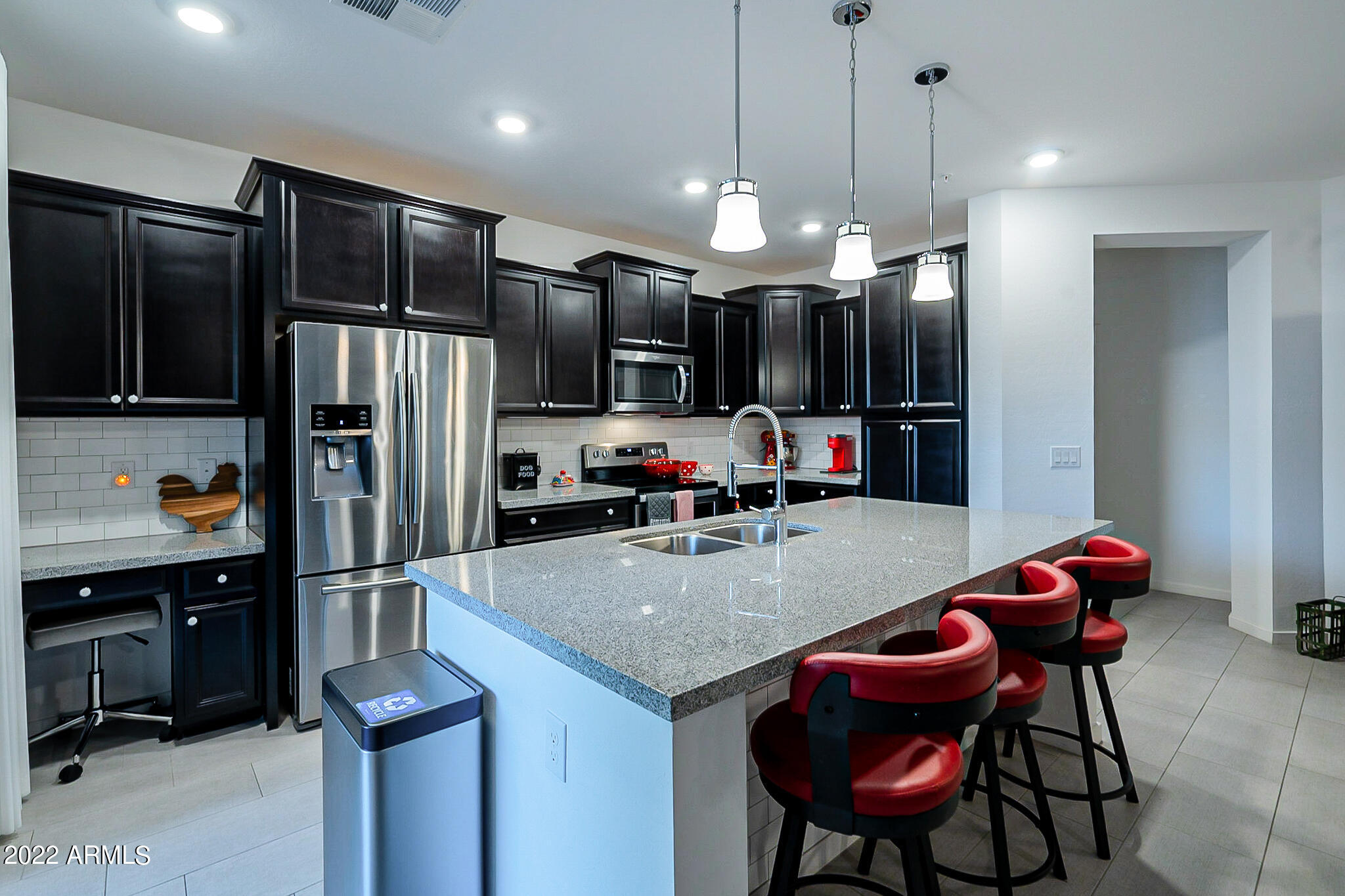 3900 East Baseline Road, Unit 142 Phoenix, AZ 85042 - Photo 6 of 28 a kitchen with granite countertop a table chairs refrigerator and microwave