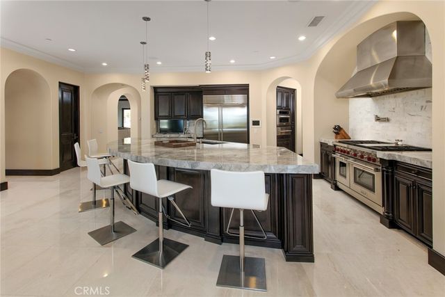 a large kitchen with a table and chairs