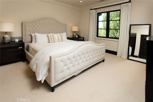 a bedroom with a bed and a balcony