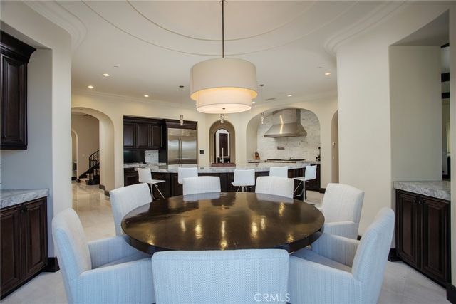 a living room with fireplace furniture and a chandelier