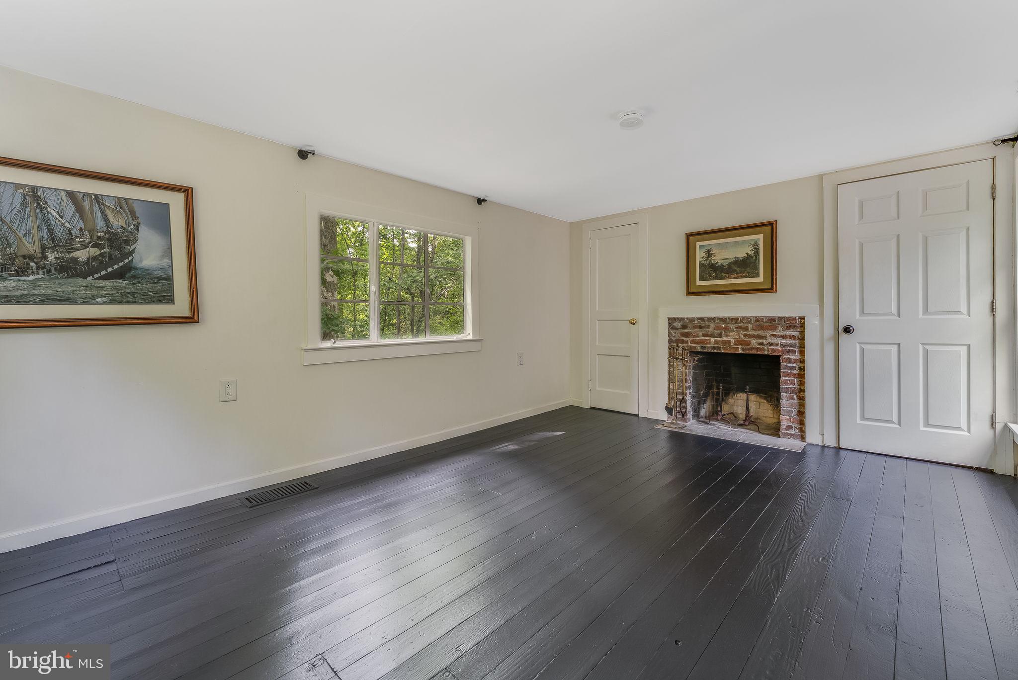 592 Province Line Road Hopewell, NJ 08525 - Photo 35 of 70 a view of an empty room with wooden floor and a window
