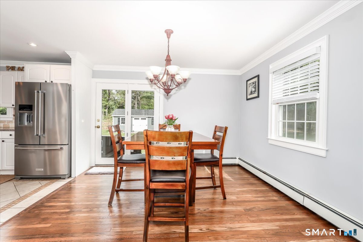 19 Botsford Hill Road Newtown, CT 06470 - Photo 13 of 40 a dining room with furniture a chandelier and wooden floor