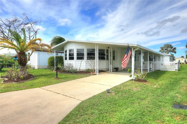 a view of a house with a backyard and porch