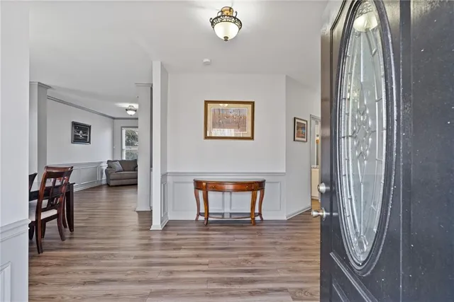 a view of a dining room with furniture and wooden floor