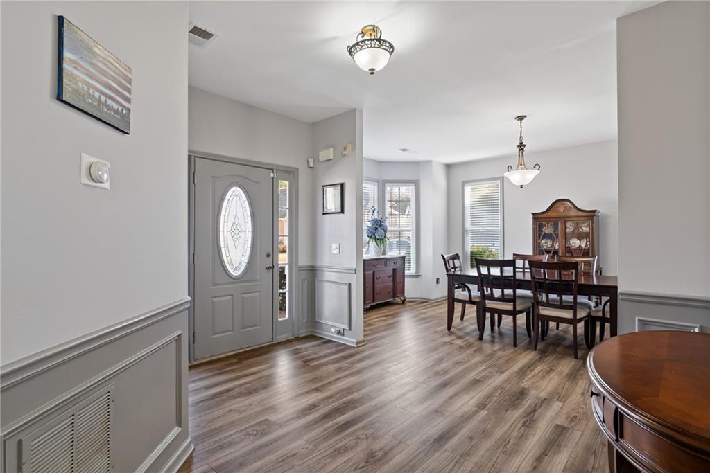 232 Springs Crossing Canton, GA 30114 - Photo 13 of 57 a view of a dining room with furniture and wooden floor