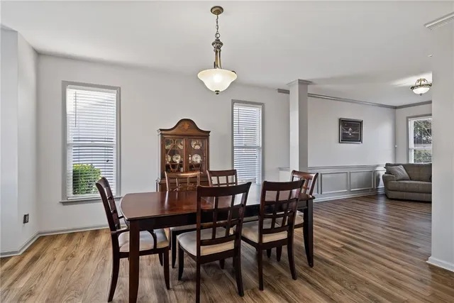 a view of a dining room with furniture window and wooden floor