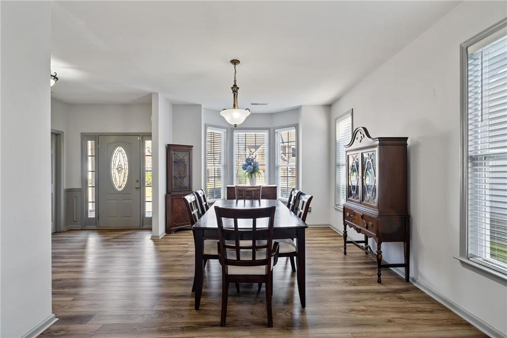 232 Springs Crossing Canton, GA 30114 - Photo 16 of 57 a view of a a dining room with furniture window and wooden floor
