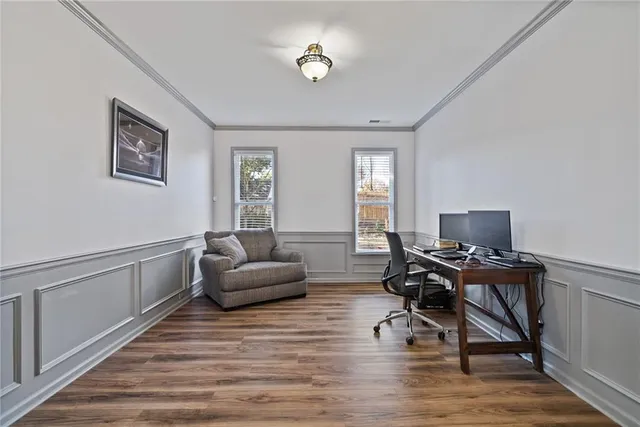 a large kitchen with granite countertop a stove a sink dishwasher a refrigerator and wooden floor