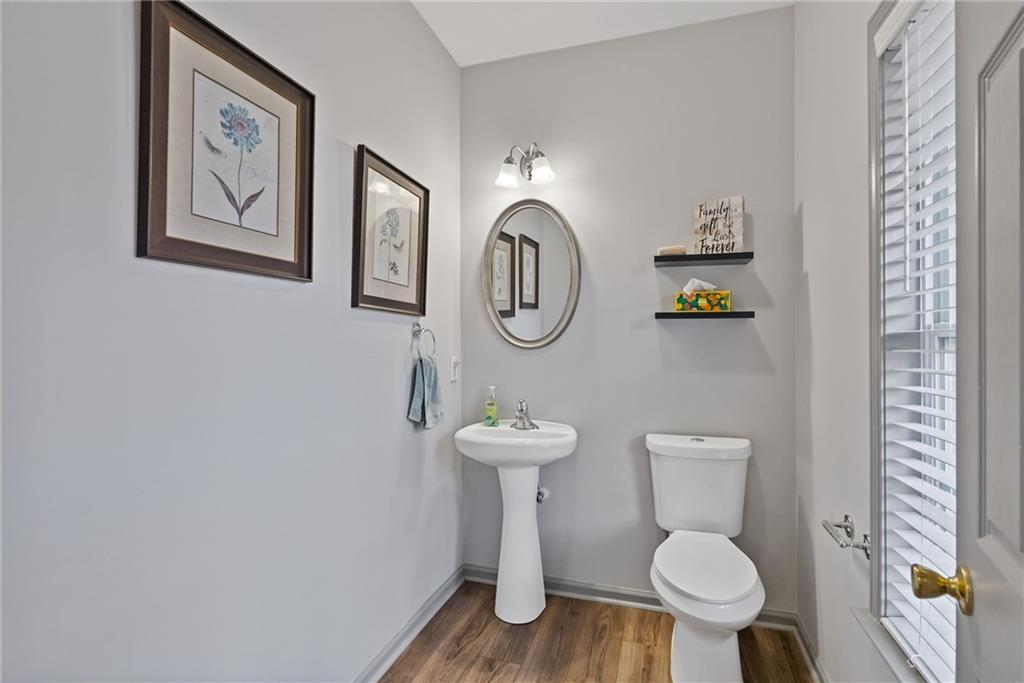 232 Springs Crossing Canton, GA 30114 - Photo 19 of 57 a bathroom with a toilet sink and mirror