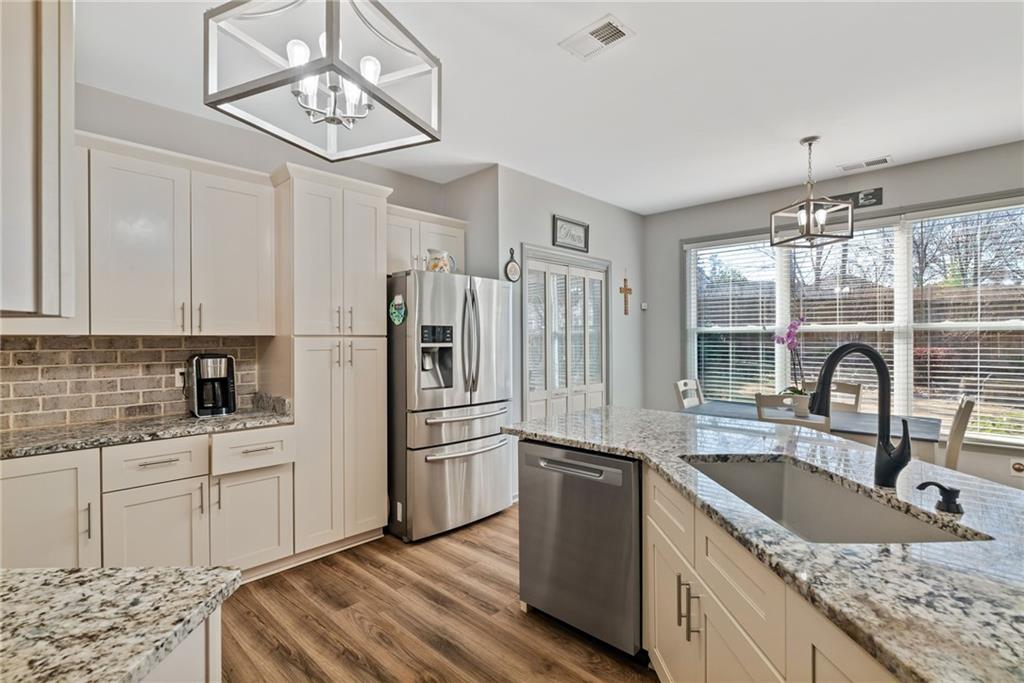 232 Springs Crossing Canton, GA 30114 - Photo 20 of 57 a kitchen with a sink appliances cabinets and a counter space