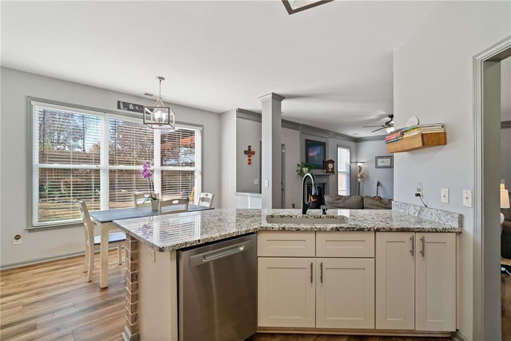 232 Springs Crossing Canton, GA 30114 - Photo 24 of 57 a kitchen with granite countertop cabinets stainless steel appliances a sink and a large window