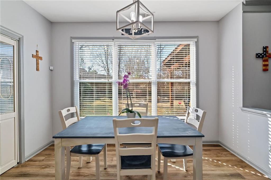 232 Springs Crossing Canton, GA 30114 - Photo 25 of 57 a view of a dining room with furniture window and wooden floor