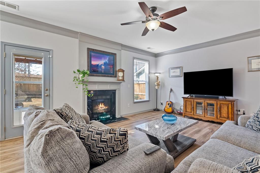 232 Springs Crossing Canton, GA 30114 - Photo 29 of 57 a living room with furniture a flat screen tv and a fireplace