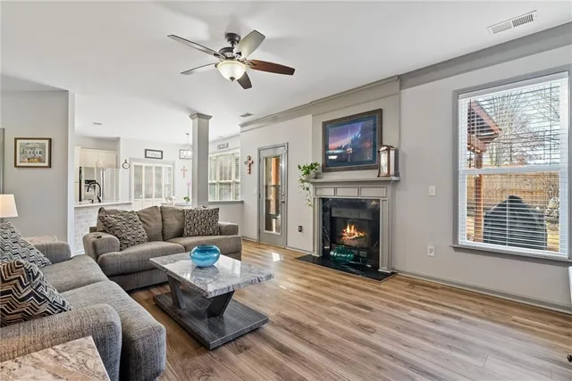 a living room with furniture and flowers