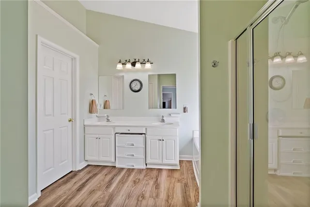 a bathroom with a bathtub a shower a sink and a mirror