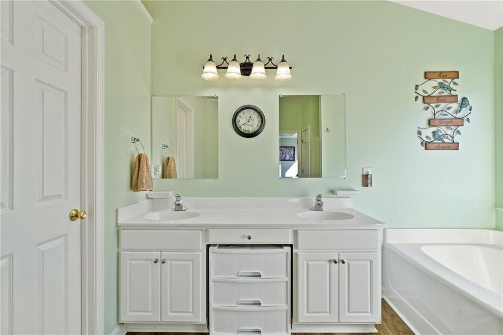 232 Springs Crossing Canton, GA 30114 - Photo 38 of 57 a bathroom with a double vanity sink mirror and bathtub