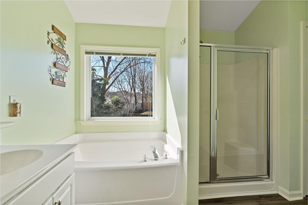 232 Springs Crossing Canton, GA 30114 - Photo 39 of 57 a bathroom with a bathtub and a shower