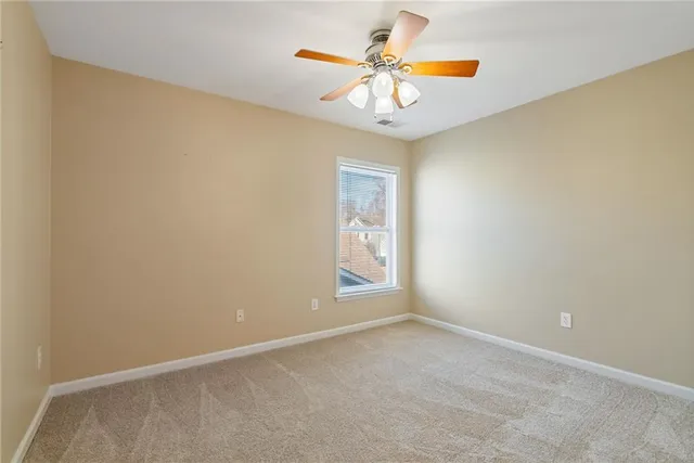 an empty room with closet and windows