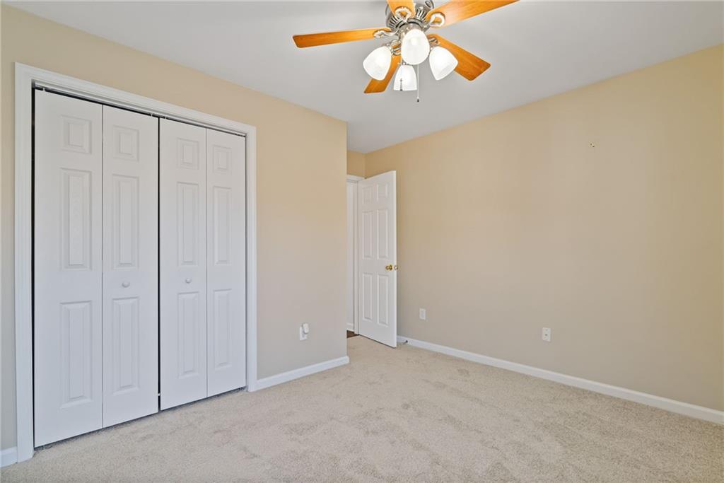 232 Springs Crossing Canton, GA 30114 - Photo 43 of 57 an empty room with a chandelier fan