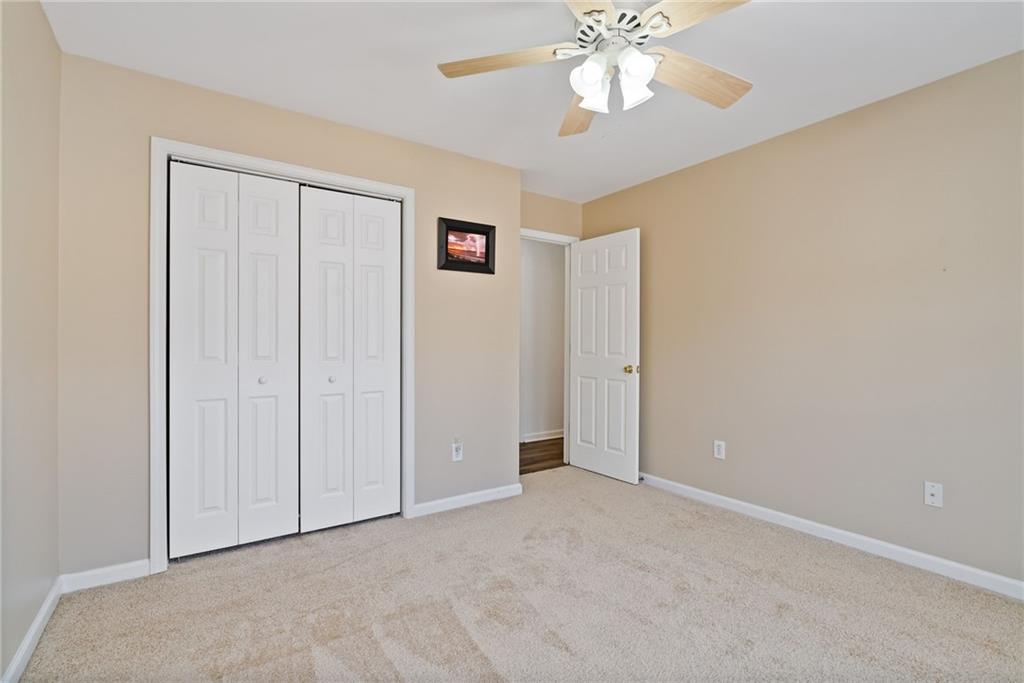 232 Springs Crossing Canton, GA 30114 - Photo 48 of 57 an empty room with a chandelier fan and windows