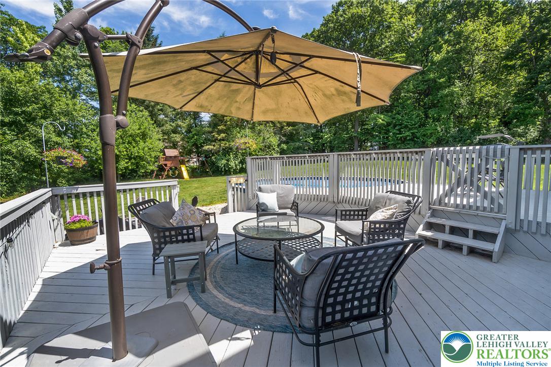 9461 Red Road Kempton, PA 19529 - Photo 37 of 55 Enjoy the summers on a spacious wooden deck for relaxation and entertaining, with a shimmering pool just beyond.