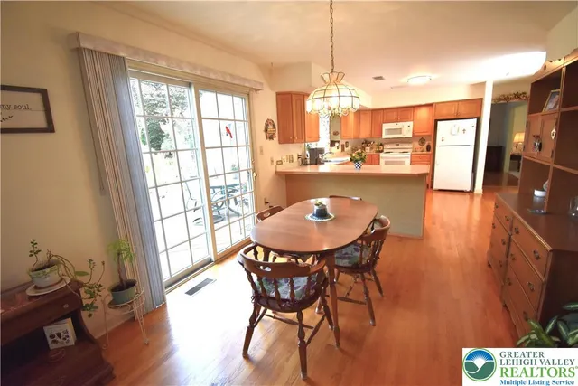 a dining room with furniture and wooden floor