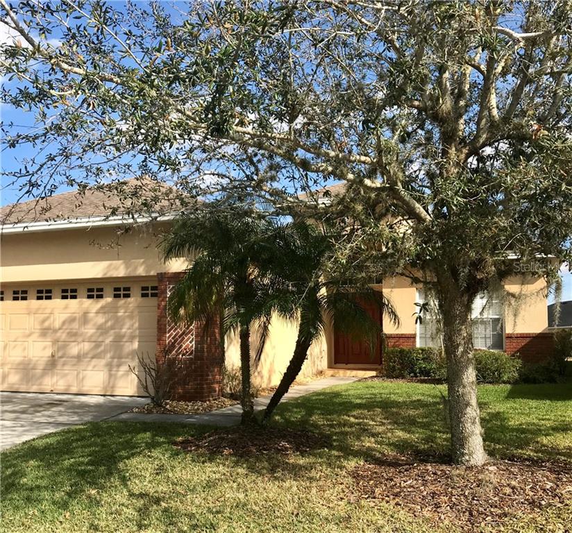6850 Eagle Ridge Loop Lakeland, FL 33813 - Photo 1 of 1 a backyard of a house with lots of green space