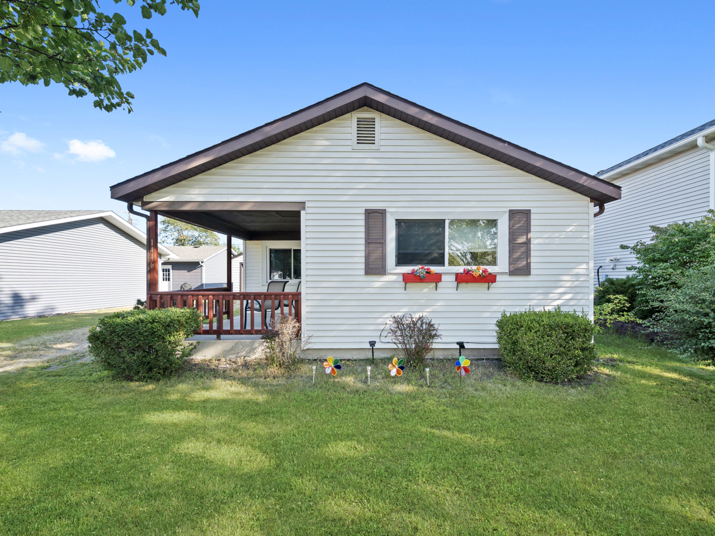 a front view of house with yard and outdoor seating