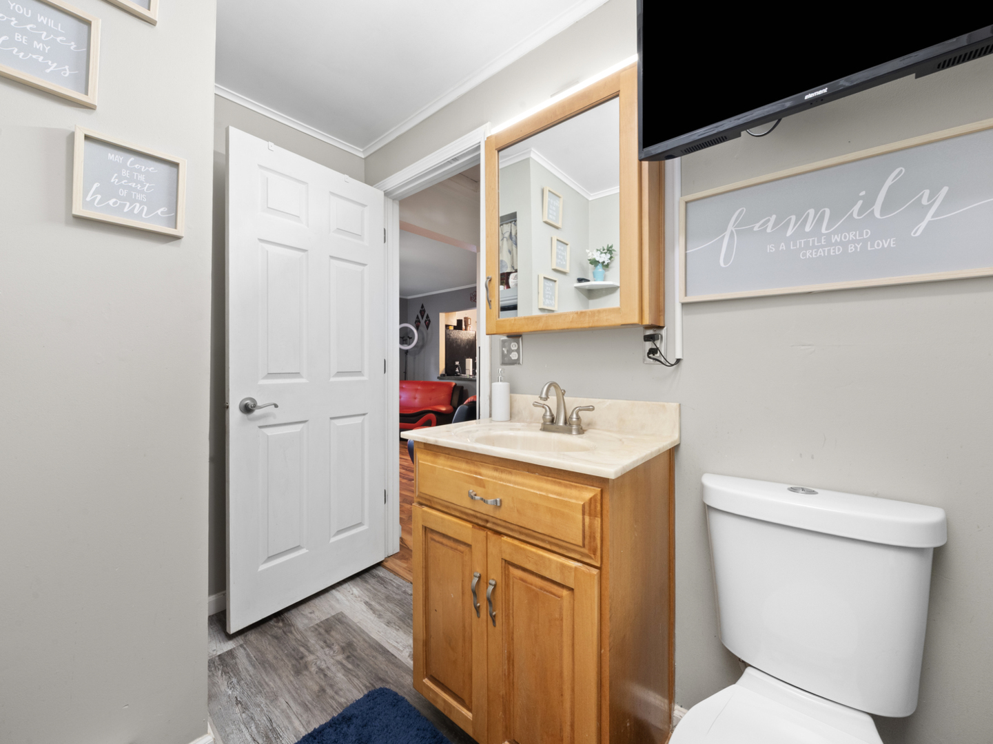 1446 Erie Street Ottawa, IL 61350 - Photo 22 of 41 a bathroom with a toilet sink and mirror