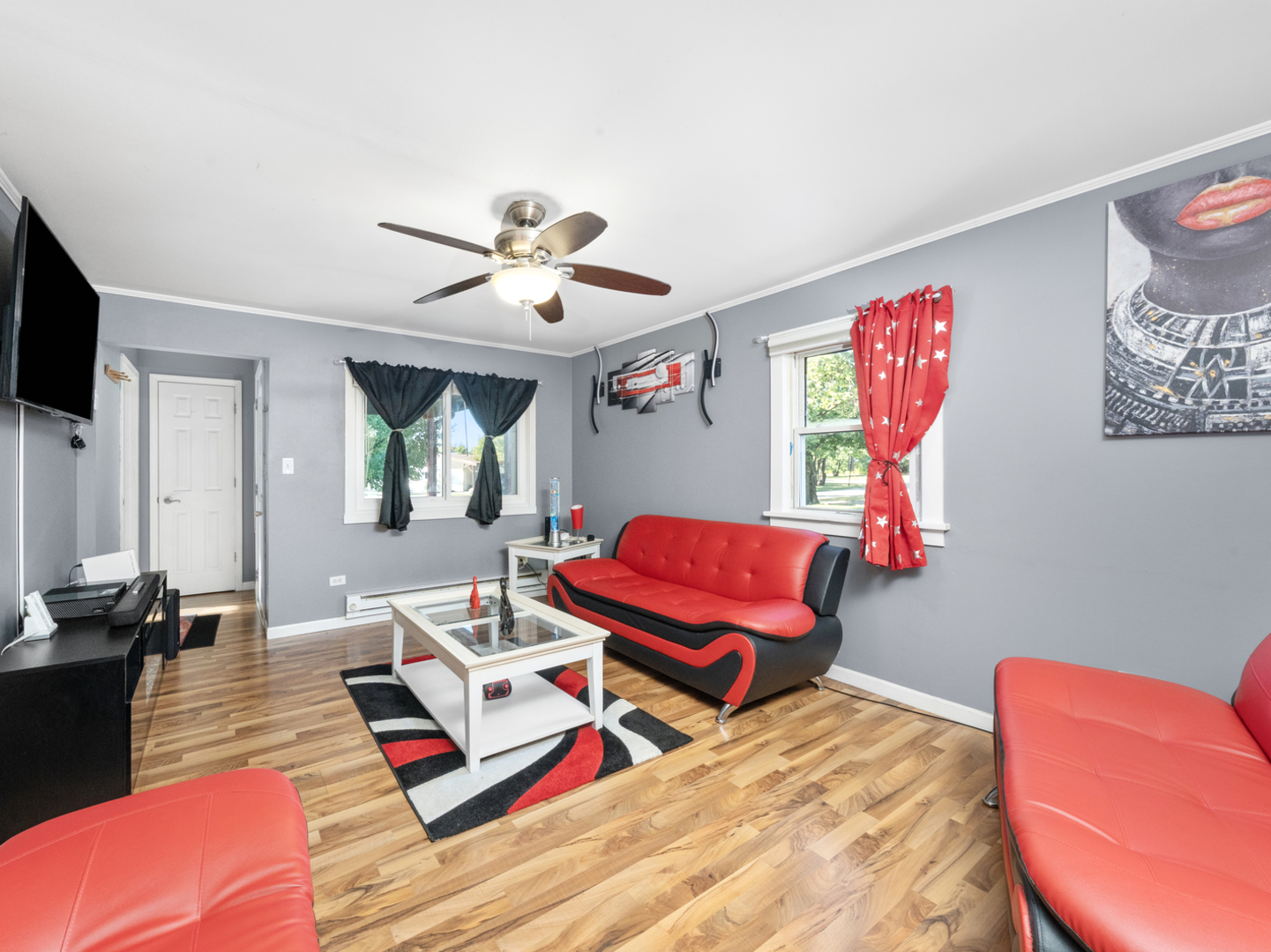 1446 Erie Street Ottawa, IL 61350 - Photo 6 of 41 a living room with furniture a flat screen tv and a large window