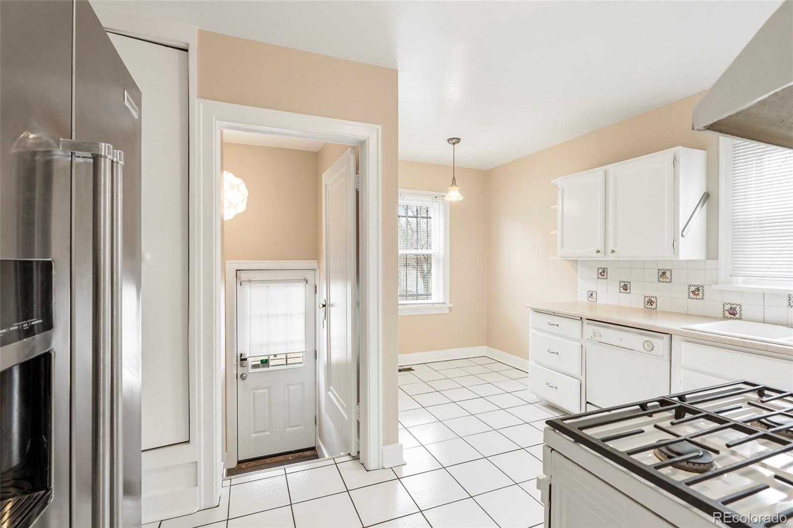 1175 Cook Street Denver, CO 80206 - Photo 12 of 42 a room with white cabinets and appliances