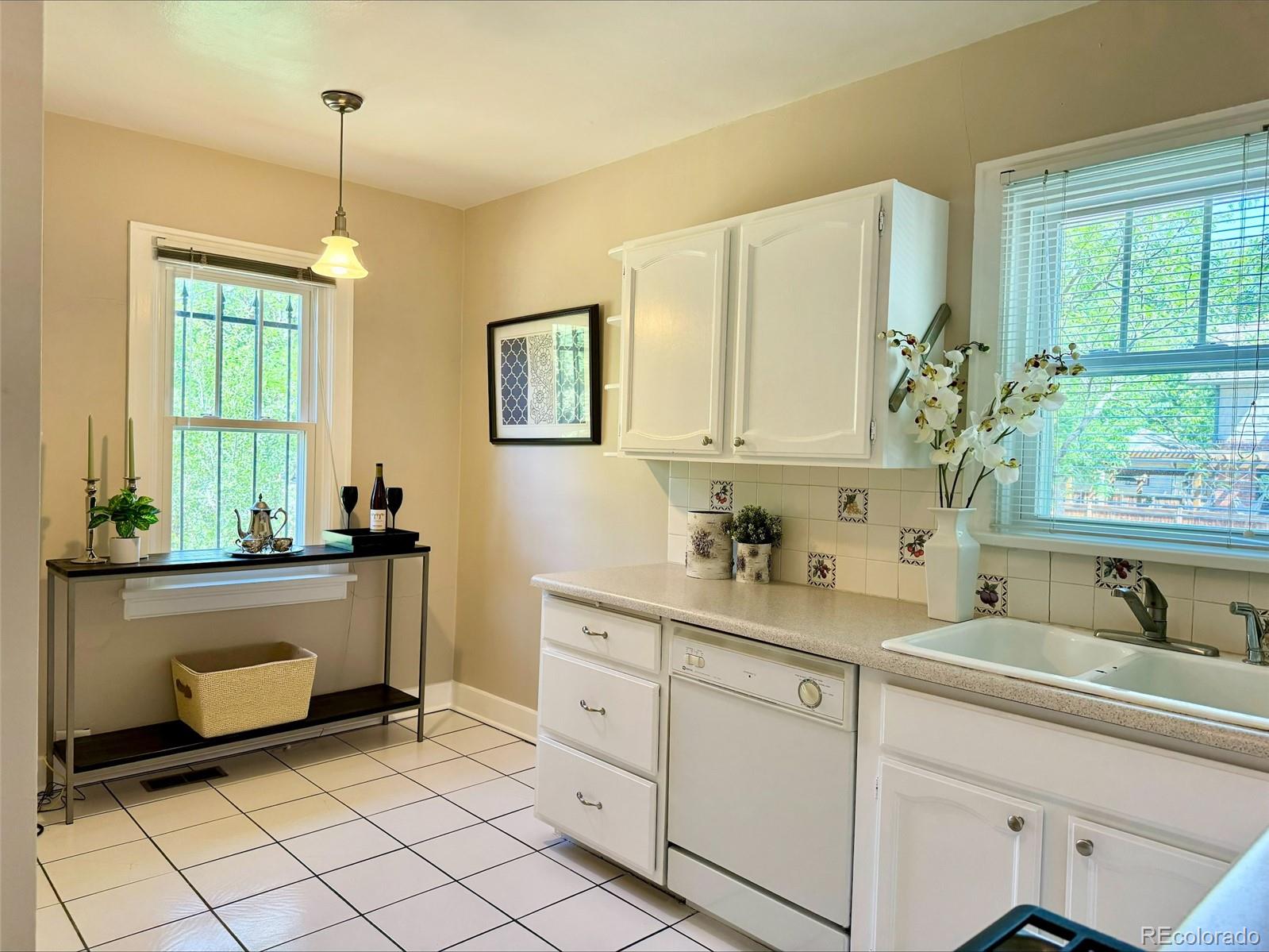 1175 Cook Street Denver, CO 80206 - Photo 14 of 42 a spacious bathroom with a sink mirror and window