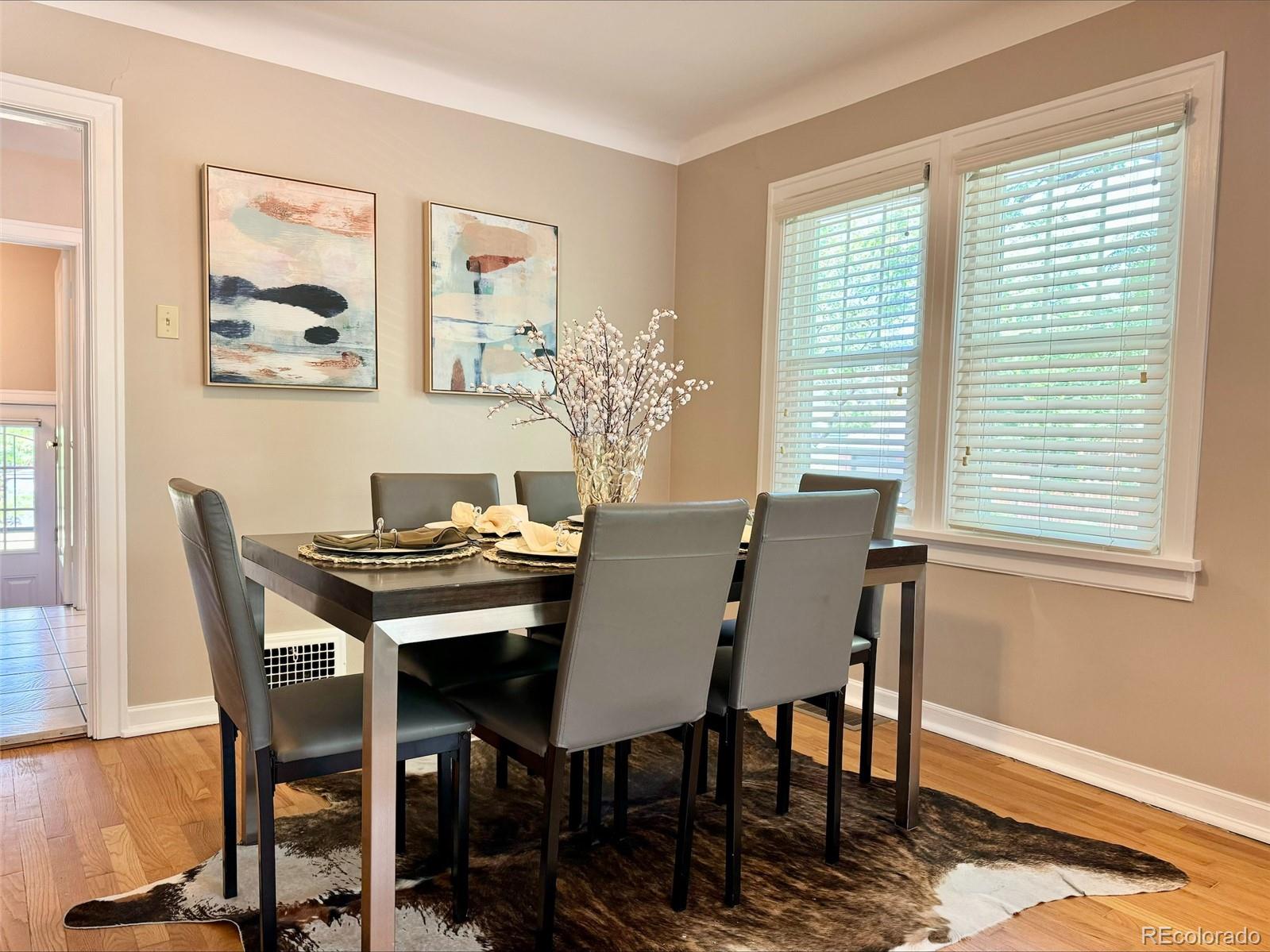 1175 Cook Street Denver, CO 80206 - Photo 16 of 42 a view of a dining room with furniture and wooden floor