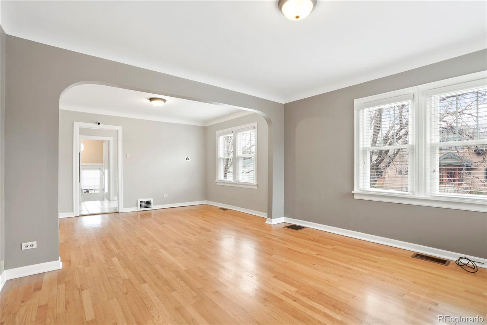 1175 Cook Street Denver, CO 80206 - Photo 18 of 42 a view of an empty room with wooden floor and a window