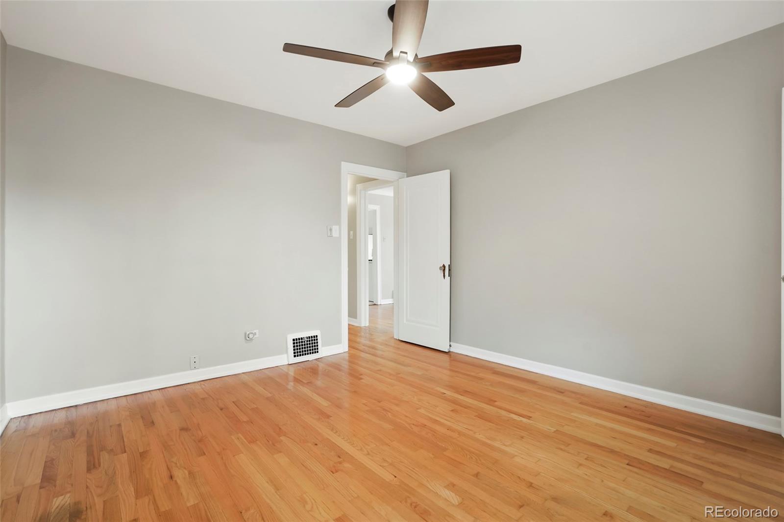 1175 Cook Street Denver, CO 80206 - Photo 21 of 42 a view of room with wooden floor and ceiling fan
