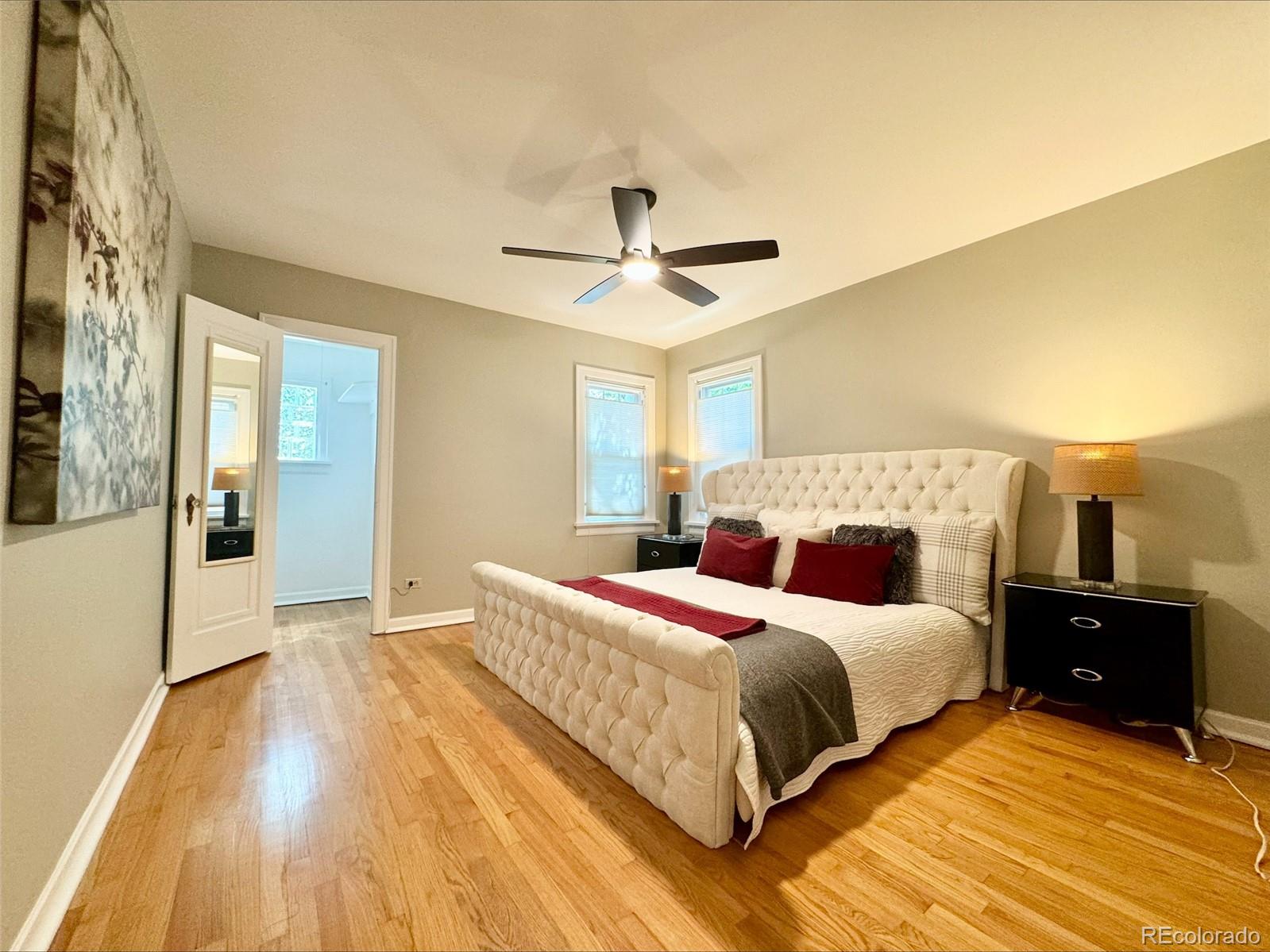 1175 Cook Street Denver, CO 80206 - Photo 22 of 42 a bedroom with a bed and a chandelier