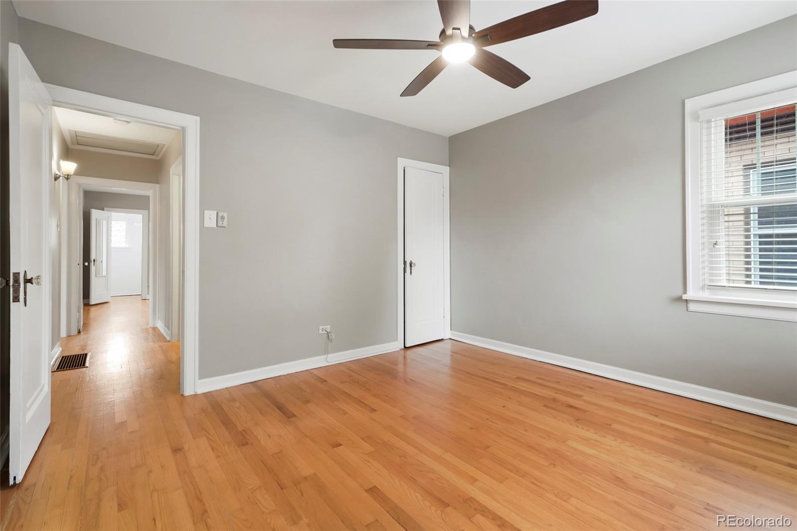 1175 Cook Street Denver, CO 80206 - Photo 23 of 42 wooden floor in an empty room with a window