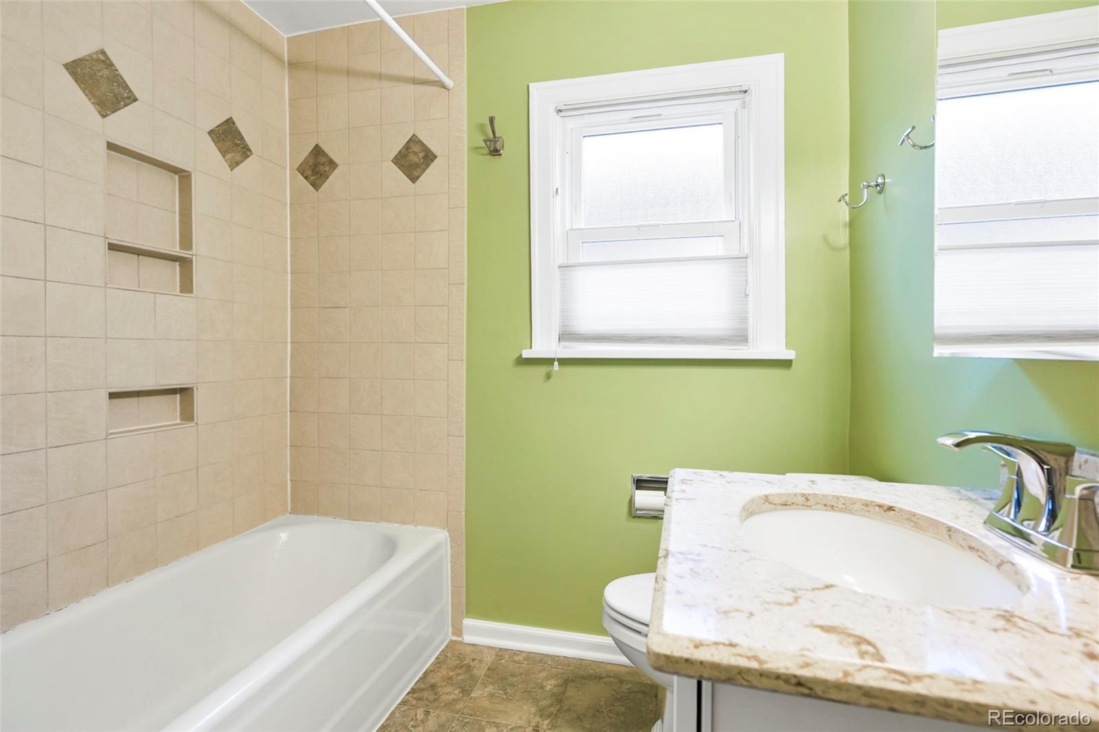 1175 Cook Street Denver, CO 80206 - Photo 25 of 42 a bathroom with a tub sink and toilet