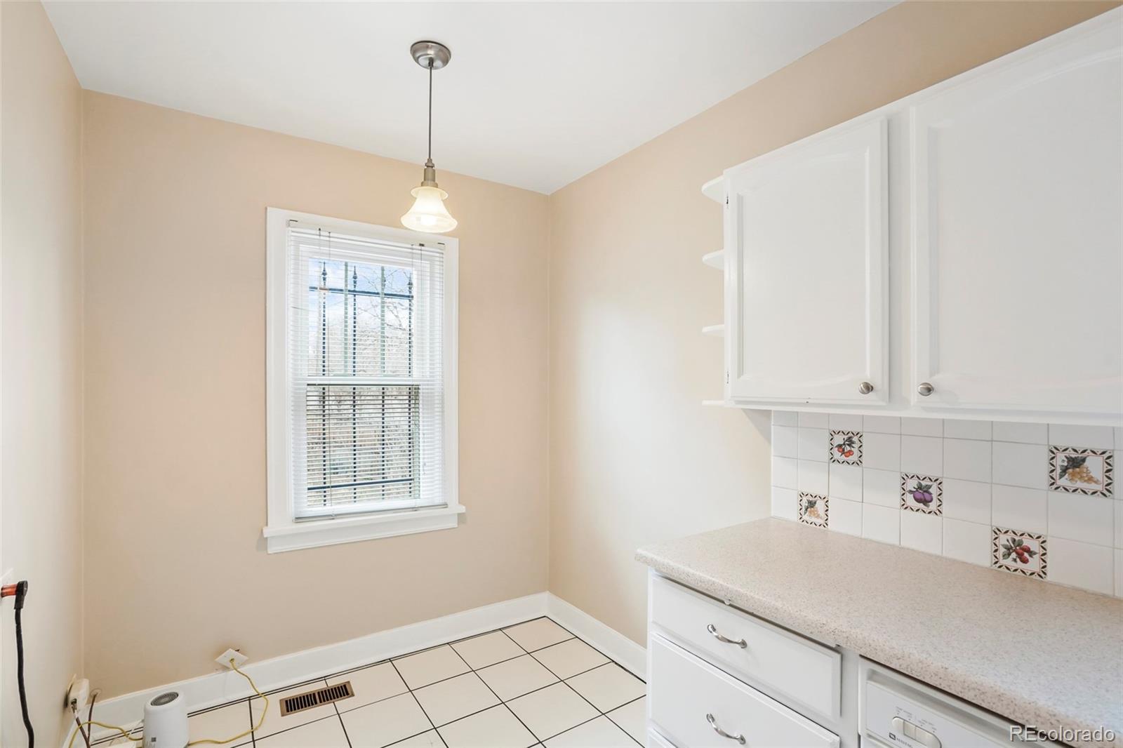 1175 Cook Street Denver, CO 80206 - Photo 30 of 42 a room with window and cabinets