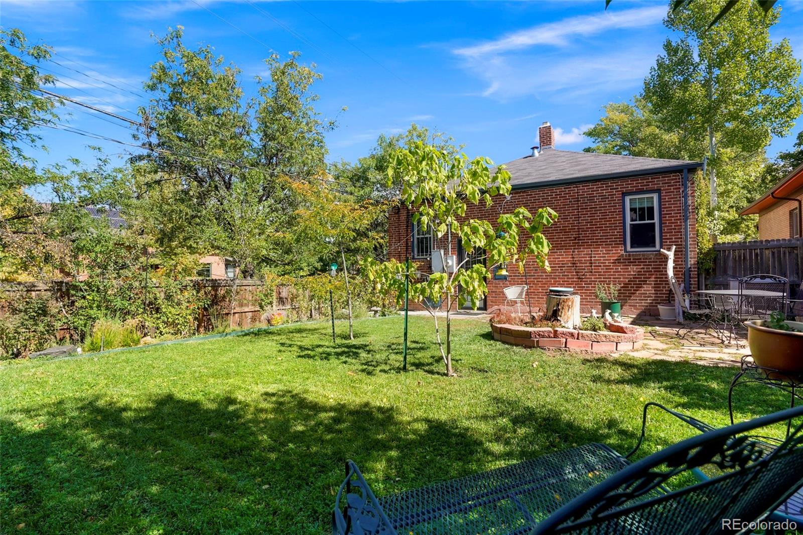 1175 Cook Street Denver, CO 80206 - Photo 35 of 42 a view of a house with backyard sitting area and garden