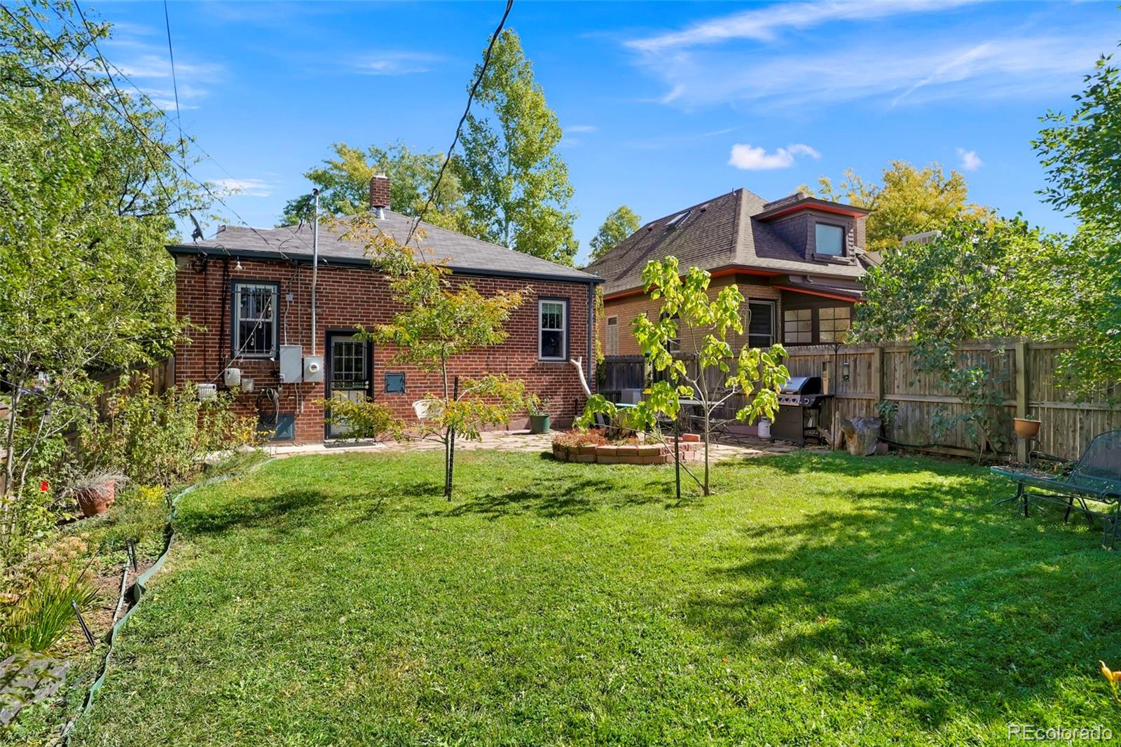 1175 Cook Street Denver, CO 80206 - Photo 36 of 42 a view of house with a backyard and a bench