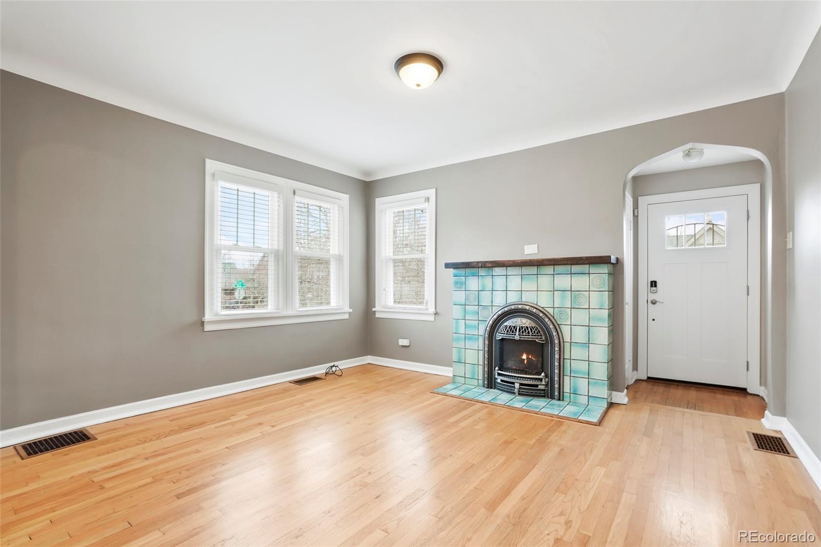 1175 Cook Street Denver, CO 80206 - Photo 9 of 42 a view of an empty room with window and wooden floor