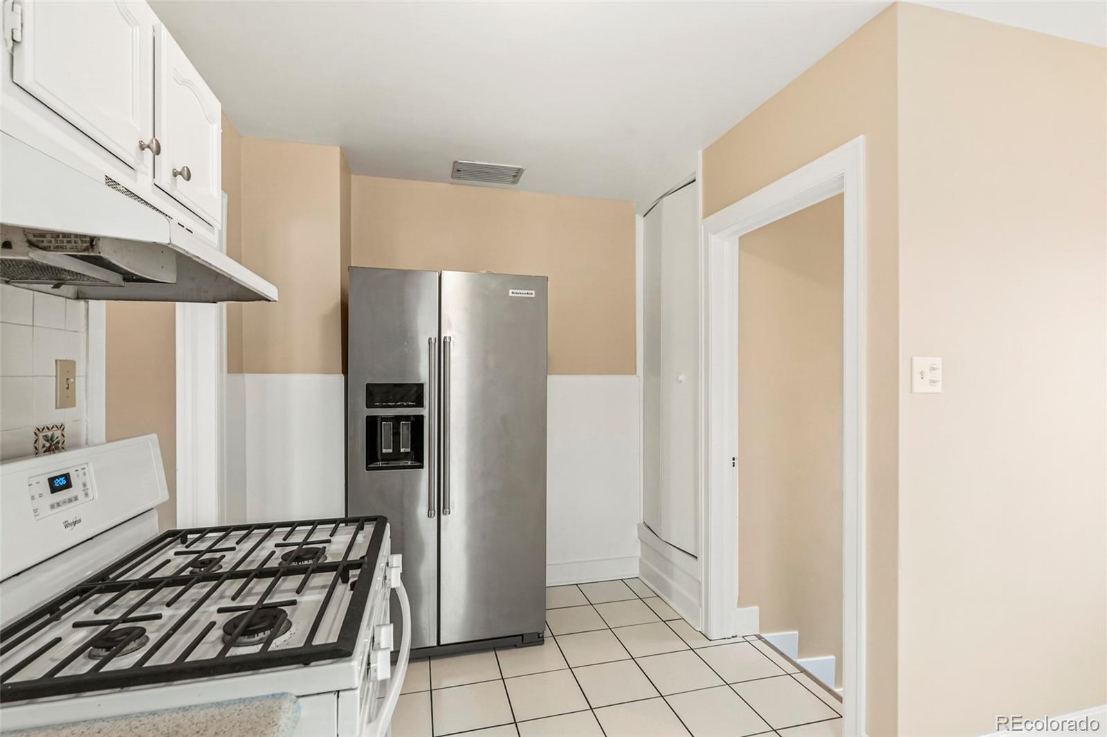 1175 Cook Street Denver, CO 80206 - Photo 10 of 42 a kitchen with a stove and a refrigerator