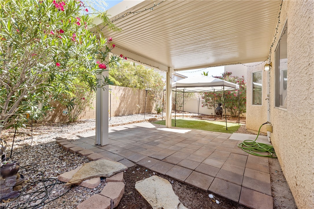 8934 Deep Ridge Court Las Vegas, NV 89178 - Photo 28 of 47 A private backyard oasis features a shaded patio, perfect for outdoor relaxation and entertaining.