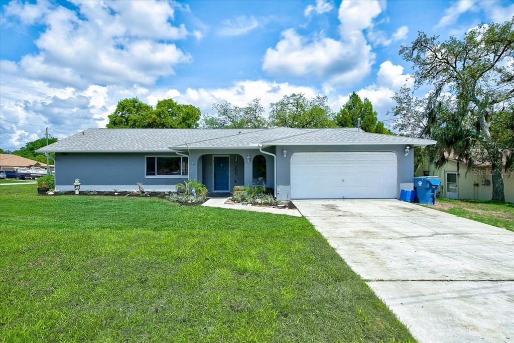 10170 Vancouver Road Spring Hill, FL 34608 - Photo 1 of 1 a front view of house with yard and green space