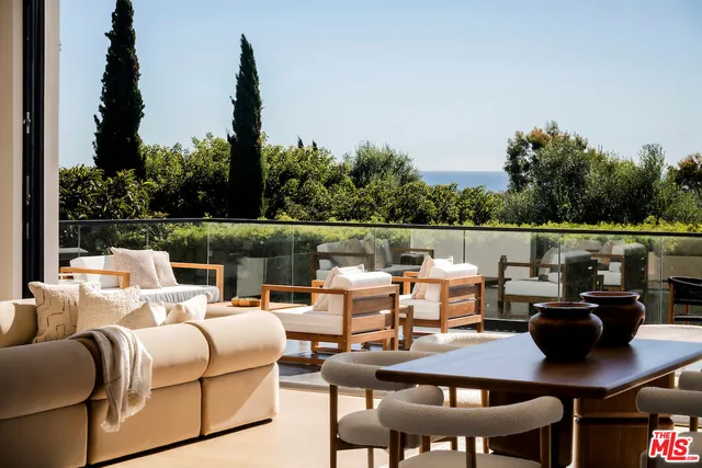 a view of a chairs and table on the balcony